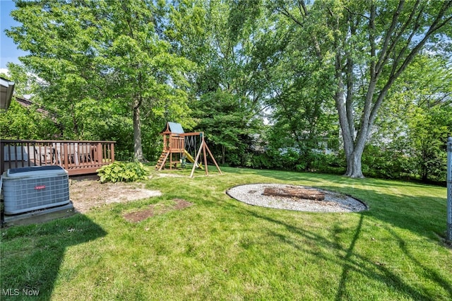 3895 Mars Dr, Brunswick, OH 44212 - view of green lawn featuring central air condition unit, a playground, and a deck