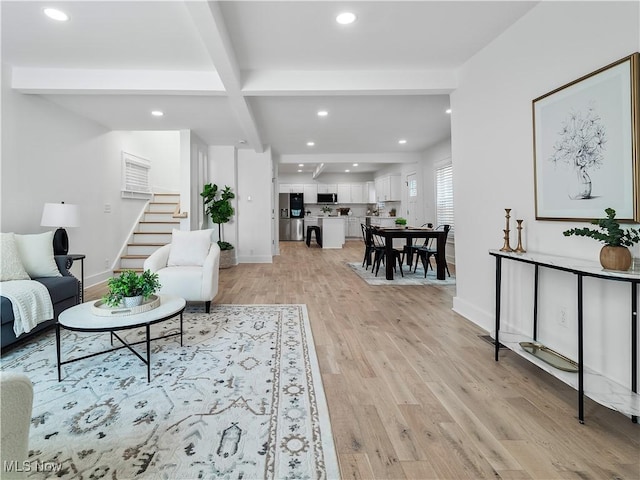 2295 Thurman Ave, Cleveland, OH 44113 - living room featuring beamed ceiling, stairway, recessed lighting, light wood-style floors, and baseboards