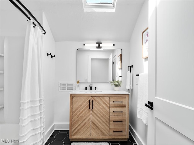 2295 Thurman Ave, Cleveland, OH 44113 - full bath featuring vanity, baseboards, vaulted ceiling, and tile patterned flooring