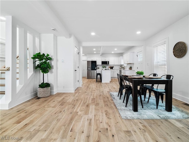 2295 Thurman Ave, Cleveland, OH 44113 - dining area with light wood finished floors, stairway, baseboards, and recessed lighting