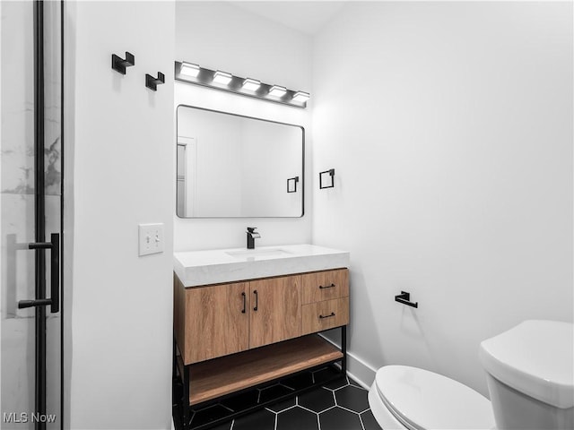 2295 Thurman Ave, Cleveland, OH 44113 - bathroom with vanity, toilet, tile patterned floors, and baseboards