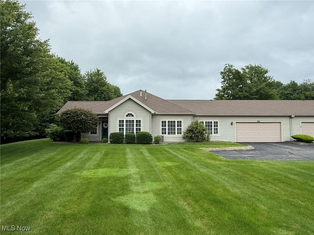 5645 Clingan Rd Unit 2D, Struthers, OH 44471 - ranch-style house with asphalt driveway, an attached garage, and a front yard