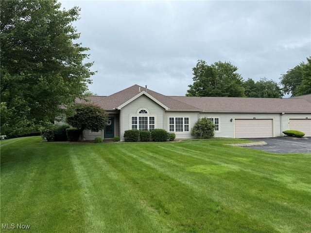 5645 Clingan Rd Unit 2D, Struthers, OH 44471 - ranch-style home featuring asphalt driveway, an attached garage, and a front lawn