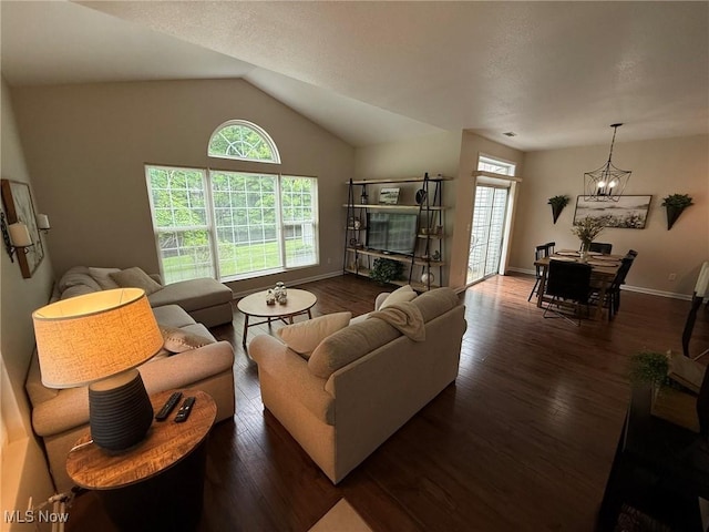 5645 Clingan Rd Unit 2D, Struthers, OH 44471 - living area featuring plenty of natural light, a chandelier, vaulted ceiling, and wood finished floors