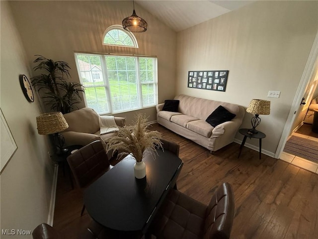 5645 Clingan Rd Unit 2D, Struthers, OH 44471 - living room with wood-type flooring, vaulted ceiling, and baseboards