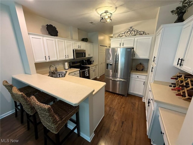5645 Clingan Rd Unit 2D, Struthers, OH 44471 - kitchen featuring stainless steel appliances, a sink, dark wood finished floors, and light countertops