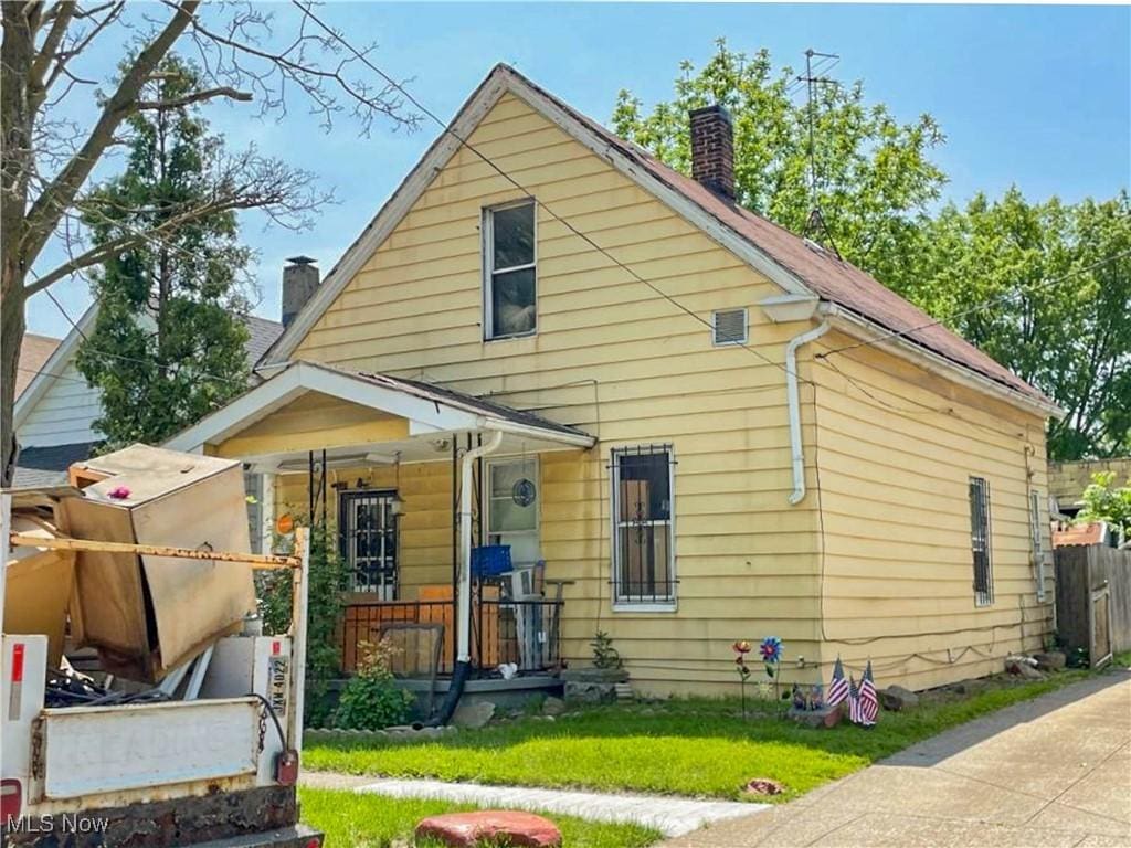 6644 Clement Ave, Cleveland, OH 44105 - back of house featuring a chimney and covered porch