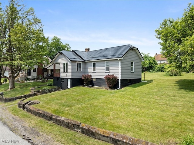 159 Locust St, Wintersville, OH 43953 - view of front of house featuring a chimney, a front lawn, metal roof, and an attached garage
