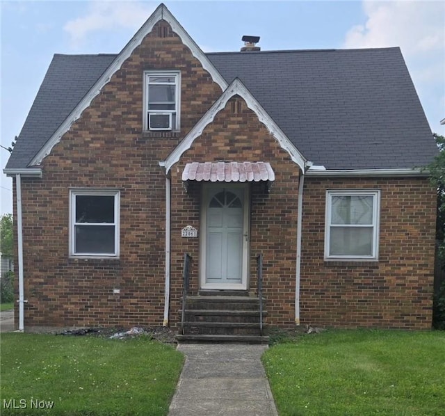 22061 Miller Ave, Euclid, OH 44119 - view of front of home with entry steps, brick siding, and a front lawn