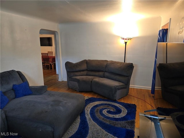22061 Miller Ave, Euclid, OH 44119 - living room with arched walkways, wood finished floors, and baseboards