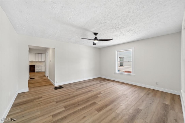 210 W 39th St, Lorain, OH 44052 - unfurnished room with a textured ceiling, light wood-style floors, and baseboards