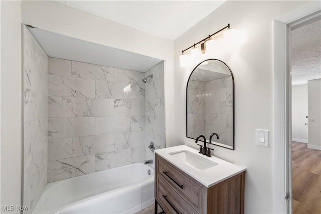 210 W 39th St, Lorain, OH 44052 - full bath with vanity, bathing tub / shower combination, and wood finished floors