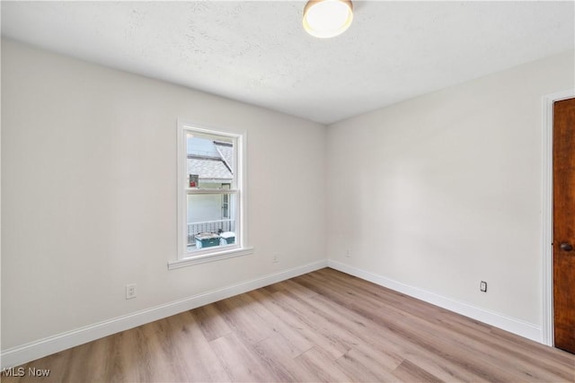 210 W 39th St, Lorain, OH 44052 - spare room featuring wood finished floors and baseboards