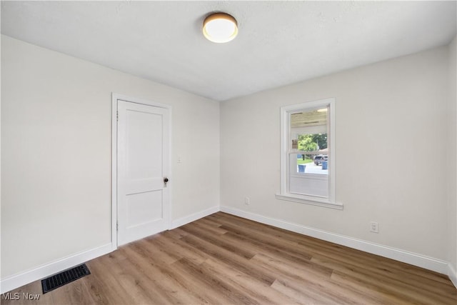 210 W 39th St, Lorain, OH 44052 - empty room featuring wood finished floors and baseboards