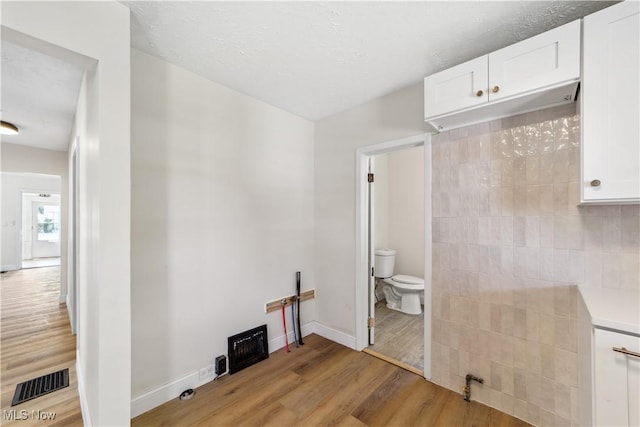 210 W 39th St, Lorain, OH 44052 - bathroom with toilet, wood finished floors, and baseboards