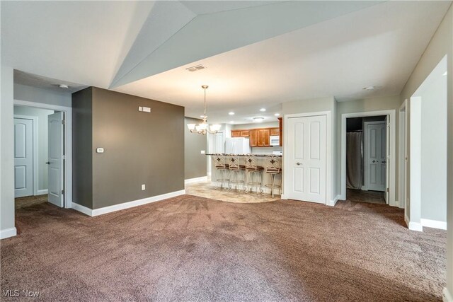165 Woodbury Glen St, Hartville, OH 44632 - unfurnished living room featuring carpet floors, a chandelier, baseboards, recessed lighting, and lofted ceiling