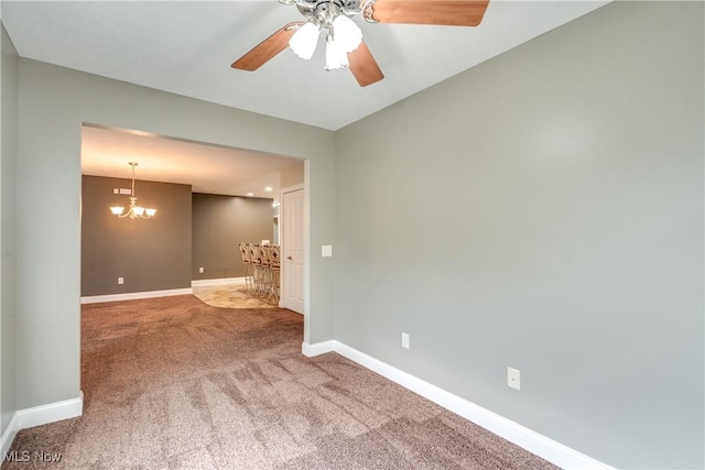 165 Woodbury Glen St, Hartville, OH 44632 - spare room featuring a chandelier, carpet floors, baseboards, and ceiling fan