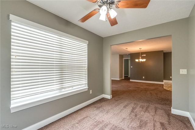 165 Woodbury Glen St, Hartville, OH 44632 - carpeted spare room with a chandelier, baseboards, and a ceiling fan