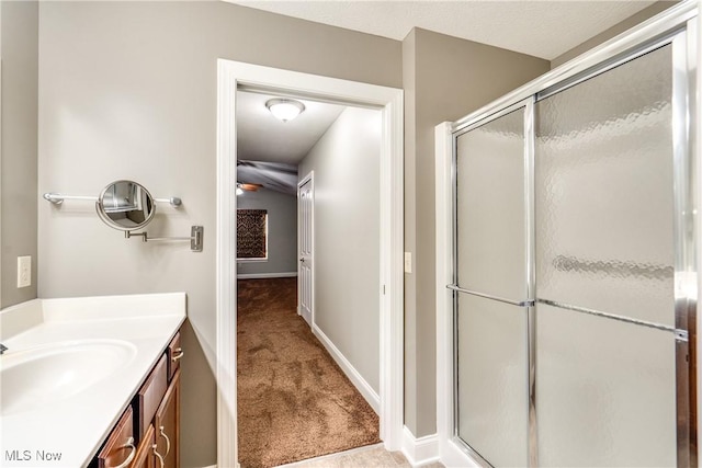 165 Woodbury Glen St, Hartville, OH 44632 - bathroom featuring vanity, a shower stall, ceiling fan, and baseboards
