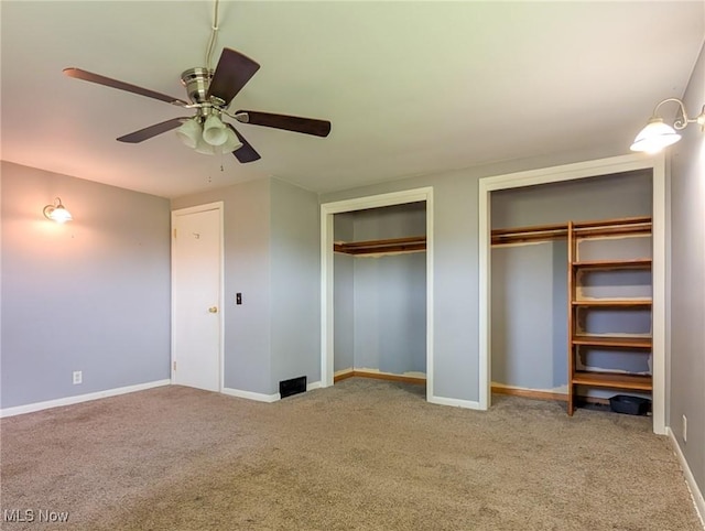3189 Union Ave SE, Minerva, OH 44657 - unfurnished bedroom featuring two closets, carpet, baseboards, and a ceiling fan