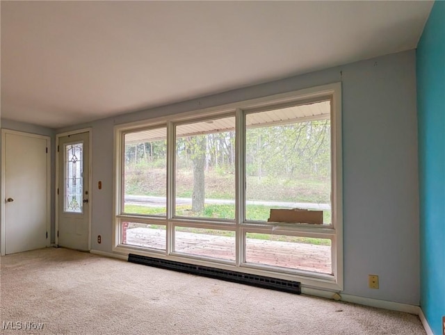 3189 Union Ave SE, Minerva, OH 44657 - carpeted empty room featuring a baseboard heating unit, healthy amount of natural light, and baseboards