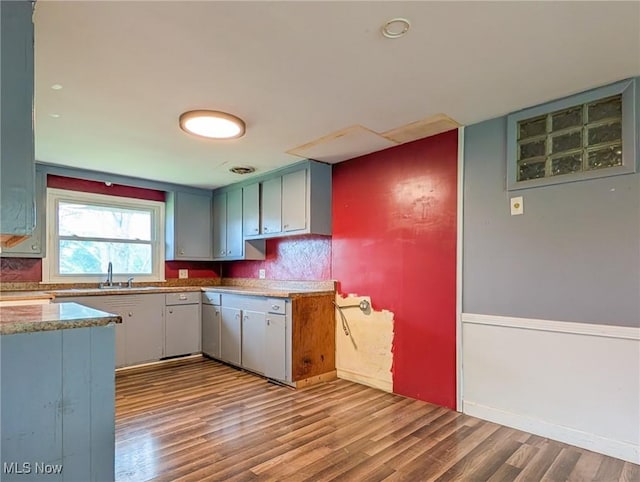 3189 Union Ave SE, Minerva, OH 44657 - kitchen featuring wood finished floors, a sink, and light stone countertops