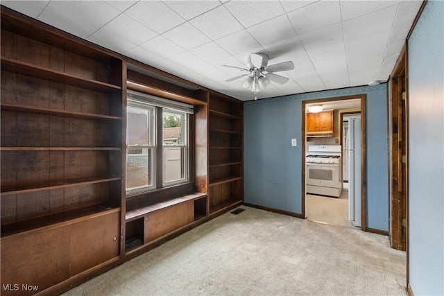 365 Stephens Rd, Akron, OH 44312 - spare room featuring light carpet, a ceiling fan, baseboards, and built in features