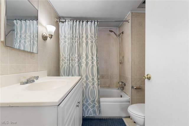 365 Stephens Rd, Akron, OH 44312 - full bathroom featuring tile walls, vanity, shower / tub combo, tile patterned flooring, and toilet