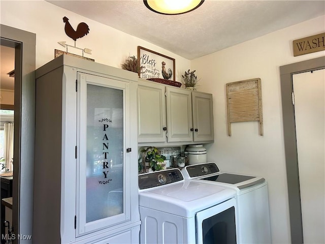 586 Columbia Rd, Valley City, OH 44280 - laundry area with cabinet space, washer and clothes dryer, and a textured ceiling