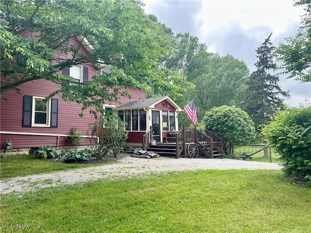 586 Columbia Rd, Valley City, OH 44280 - view of front of property with a sunroom, a deck, and a front yard