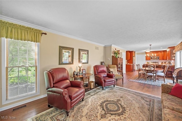 11291 Highland View Dr, Chardon, OH 44024 - living area with ornamental molding, wood finished floors, a chandelier, and baseboards