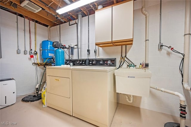 11291 Highland View Dr, Chardon, OH 44024 - laundry room with washing machine and clothes dryer, cabinet space, and concrete block wall
