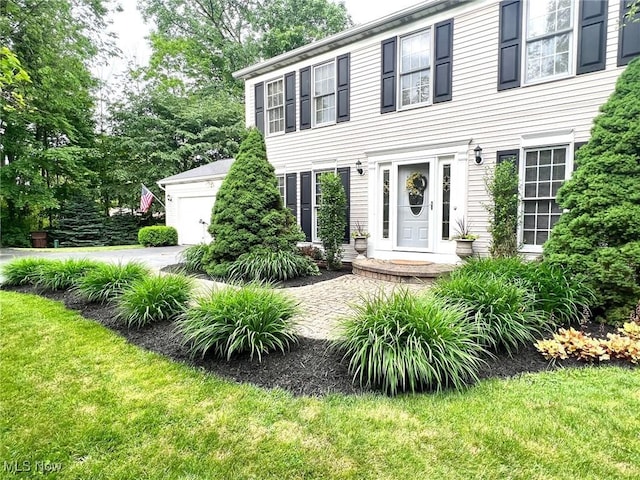 11291 Highland View Dr, Chardon, OH 44024 - colonial-style house with a front yard and an attached garage