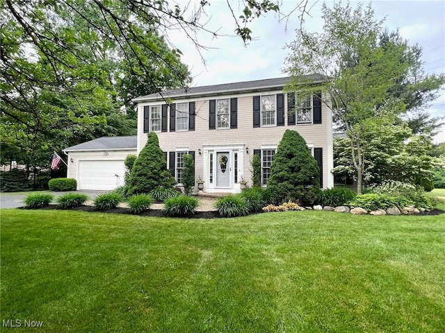 11291 Highland View Dr, Chardon, OH 44024 - colonial-style house with an attached garage, a front lawn, and concrete driveway