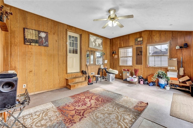 14901 Krems Ave, Maple Heights, OH 44137 - living room with a ceiling fan, carpet floors, wooden walls, and vaulted ceiling
