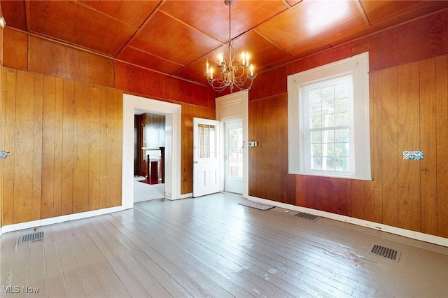 9031 State Route 213, Toronto, OH 43964 - empty room with a chandelier, hardwood / wood-style flooring, and wood walls