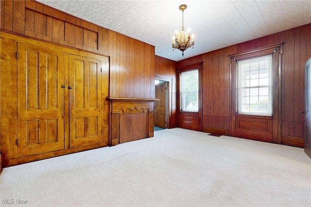 9031 State Route 213, Toronto, OH 43964 - carpeted empty room featuring a chandelier and wood walls
