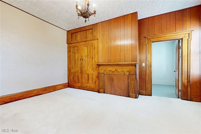 9031 State Route 213, Toronto, OH 43964 - unfurnished room featuring wooden walls, baseboards, a chandelier, and carpet