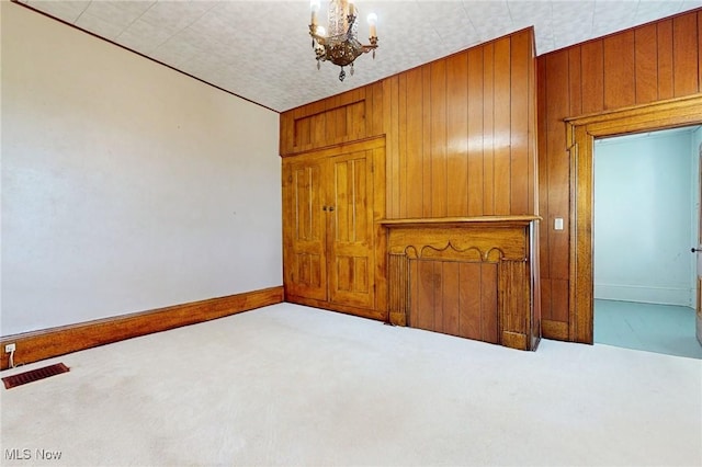 9031 State Route 213, Toronto, OH 43964 - carpeted empty room featuring a chandelier, baseboards, and wood walls