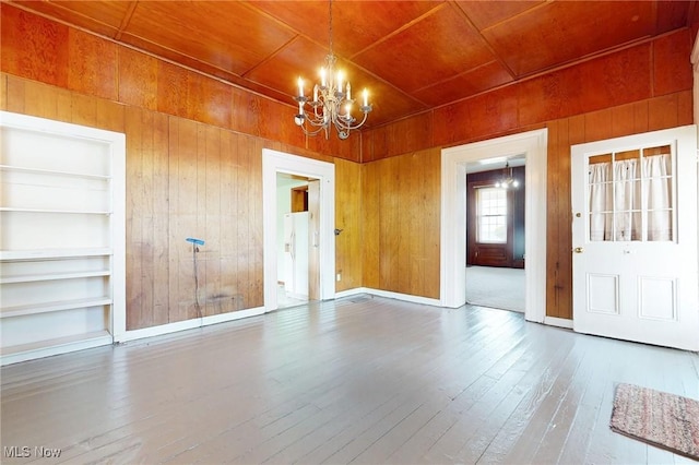 9031 State Route 213, Toronto, OH 43964 - unfurnished dining area featuring wood walls, wooden ceiling, a chandelier, built in shelves, and wood-type flooring