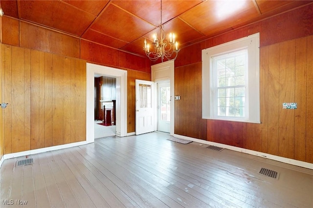 9031 State Route 213, Toronto, OH 43964 - unfurnished room featuring a chandelier, hardwood / wood-style floors, wood walls, healthy amount of natural light, and wooden ceiling