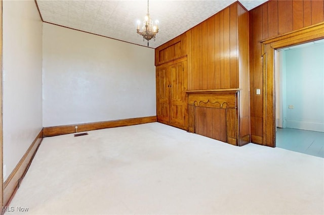 9031 State Route 213, Toronto, OH 43964 - spare room featuring carpet flooring, a chandelier, baseboards, and wooden walls