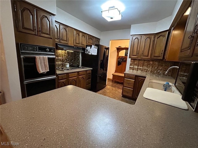 212 Coventry Rd, Marietta, OH 45750 - kitchen featuring black appliances, under cabinet range hood, a sink, tasteful backsplash, and dark brown cabinets