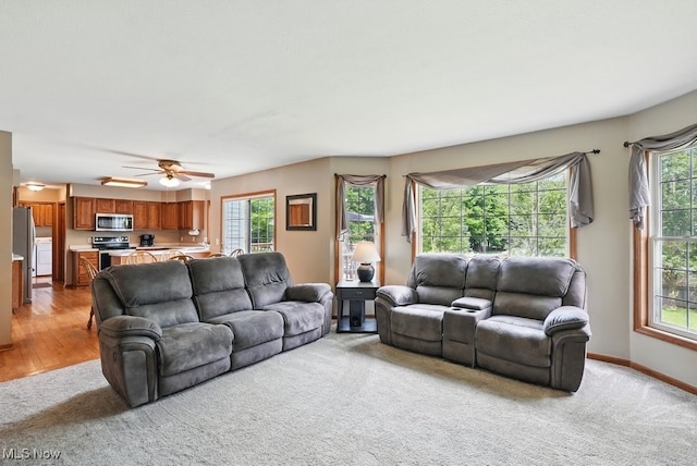 3385 Marsh Rd, Stow, OH 44224 - living area featuring light carpet, ceiling fan, and baseboards
