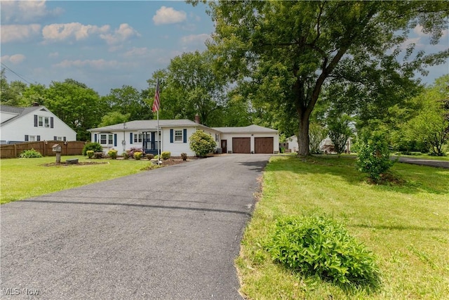1110 Warren Rd, Newton Falls, OH 44444 - single story home with asphalt driveway, an attached garage, and view of scattered trees
