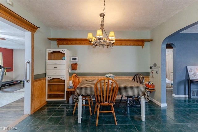 1110 Warren Rd, Newton Falls, OH 44444 - tiled dining room with a chandelier and arched walkways
