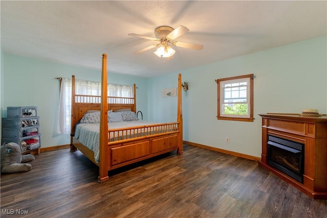 1110 Warren Rd, Newton Falls, OH 44444 - bedroom featuring dark wood-type flooring, baseboards, and a glass covered fireplace