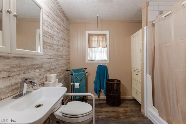 1110 Warren Rd, Newton Falls, OH 44444 - full bath featuring wooden walls, a sink, a shower stall, wood finished floors, and toilet