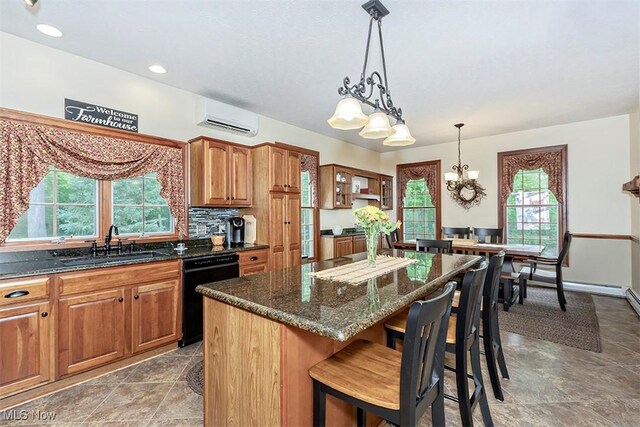 4255 River Rd, Perry, OH 44081 - kitchen with black dishwasher, a sink, a wall mounted air conditioner, a chandelier, and brown cabinetry
