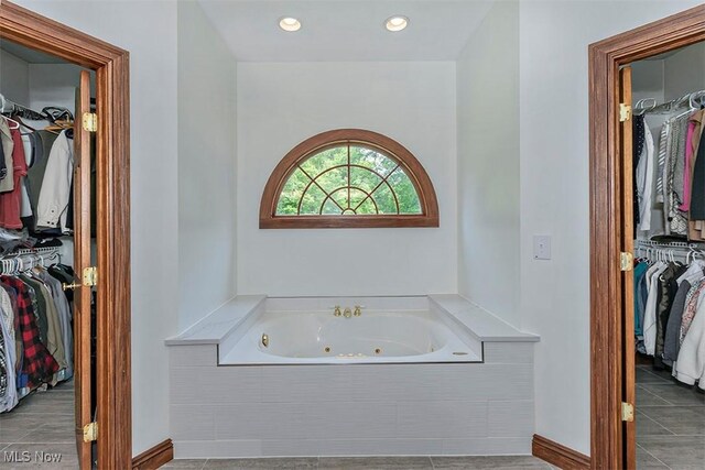 4255 River Rd, Perry, OH 44081 - bathroom with a walk in closet, a whirlpool tub, tile patterned flooring, and recessed lighting
